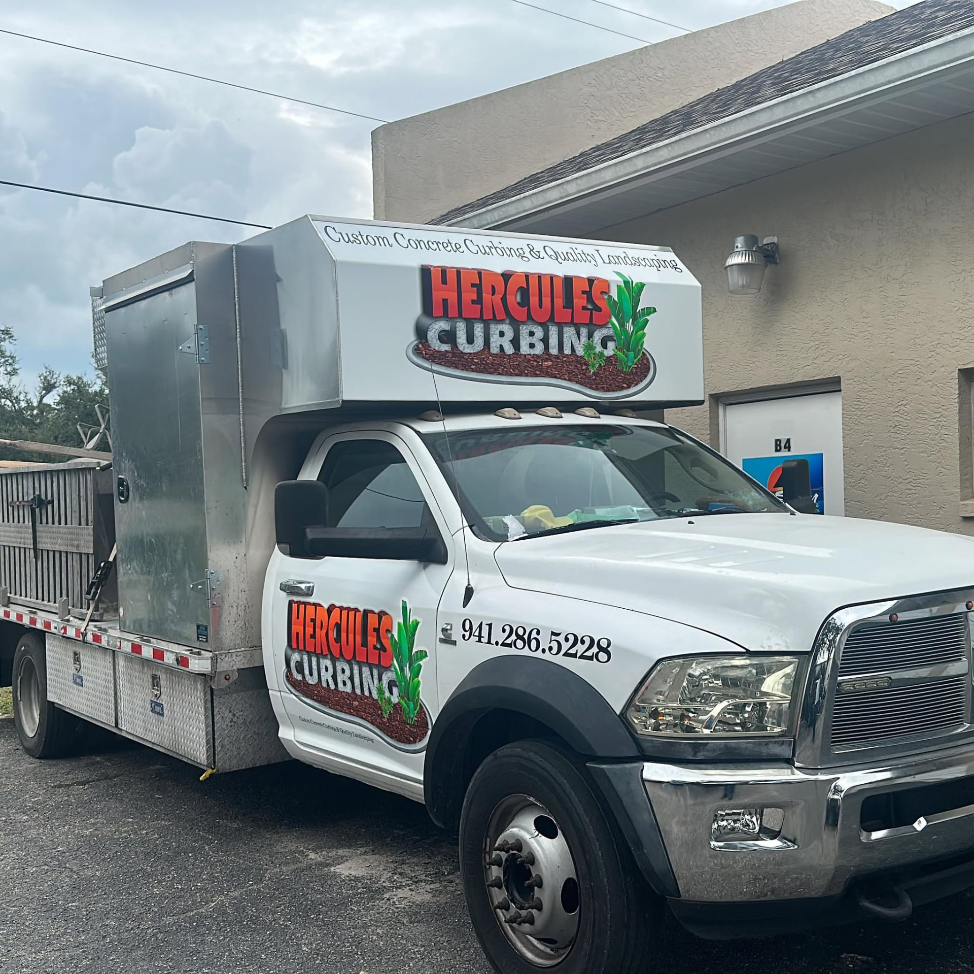 Hercules Curbing branded work truck with custom concrete curbing machine